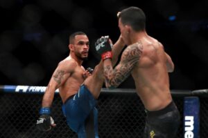 Rob Font kicks against Thomas Almeida in their Bantamweight fight during UFC 220