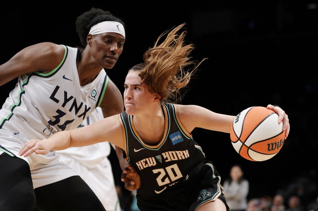 Guard Sabrina Ionescu #20 of the New York Liberty dribbles as center Sylvia Fowles #34 of the Minnesota Lynx defends.