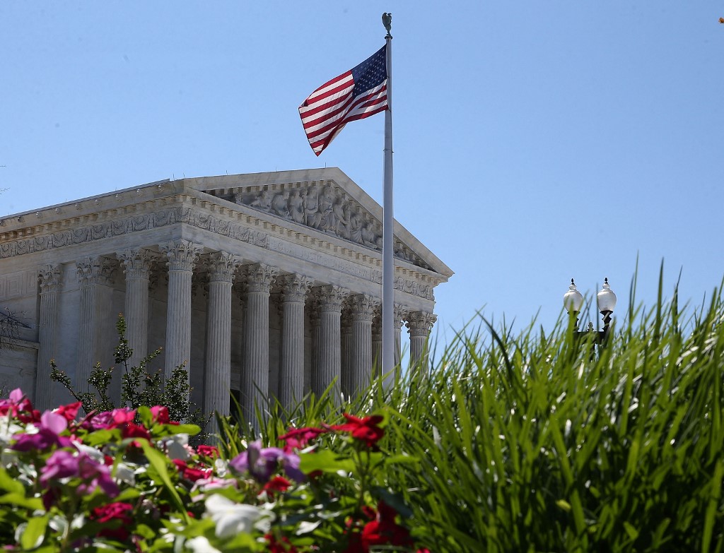 US Sports Betting Market, American flag US Supreme Court building, flowers and grass.