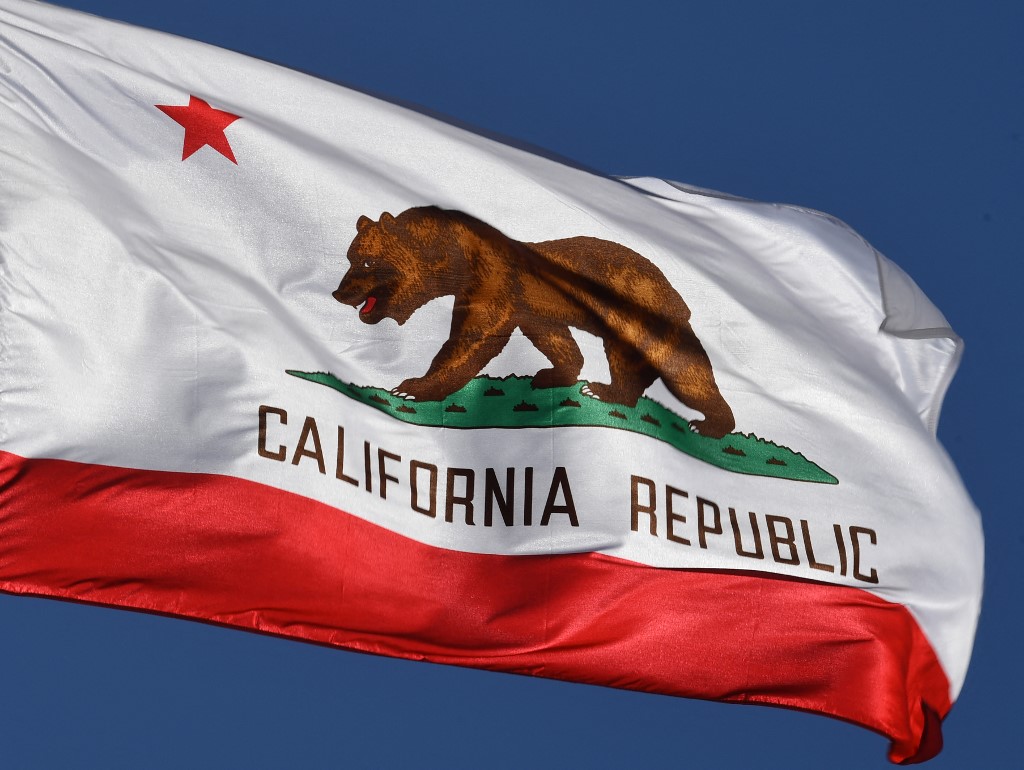 The California State flag flies outside City Hall.