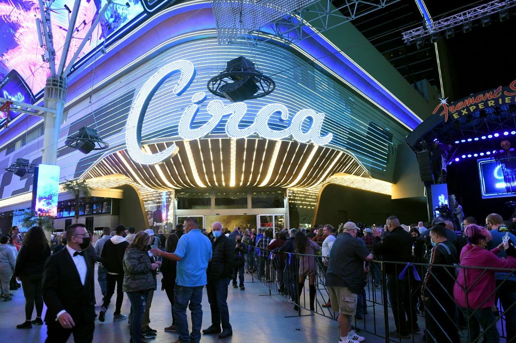Guests stand in line at the Fremont Street Experience as they wait to enter Circa Resort & Casino.