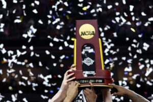 The Kansas Jayhawks celebrate with the trophy after defeating the North Carolina Tar Heels in the championship, a stunning finish for the March Madness odds favorites.