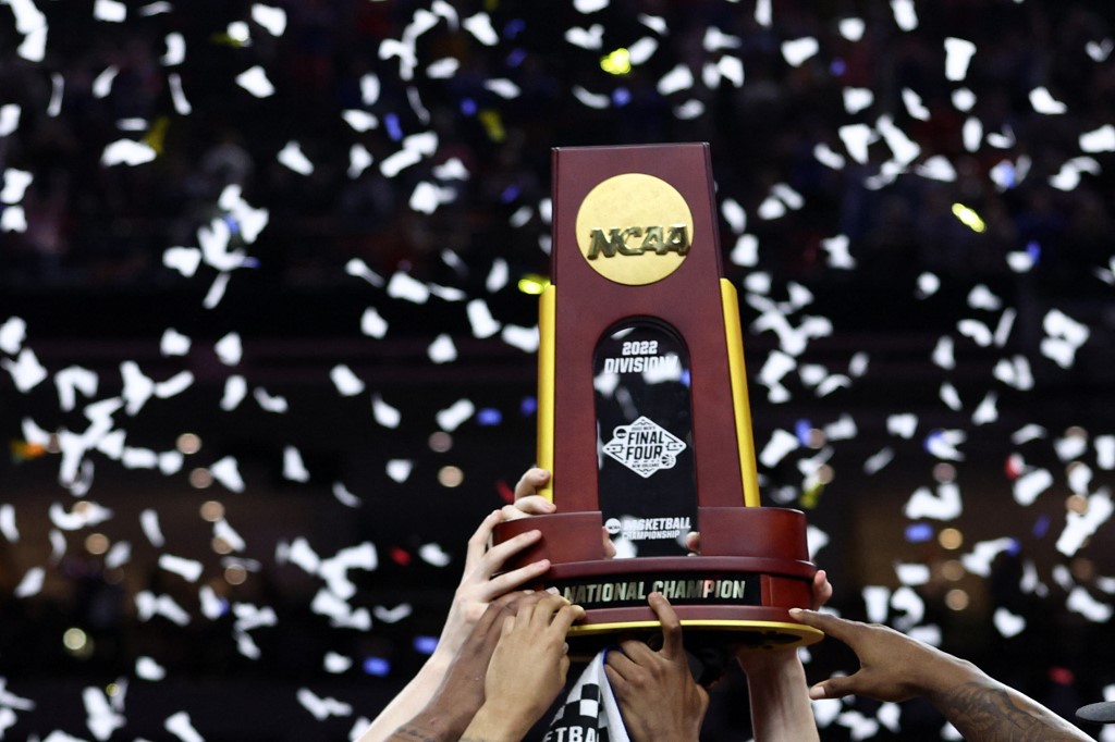 The Kansas Jayhawks celebrate with the trophy after defeating the North Carolina Tar Heels in the championship, a stunning finish for the March Madness odds favorites.
