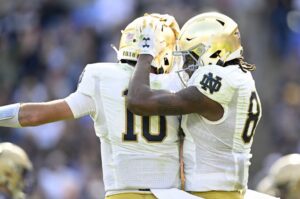 Notre Dame Fighting Irish layers celebrate after a touchdown against the Navy Midshipmen.