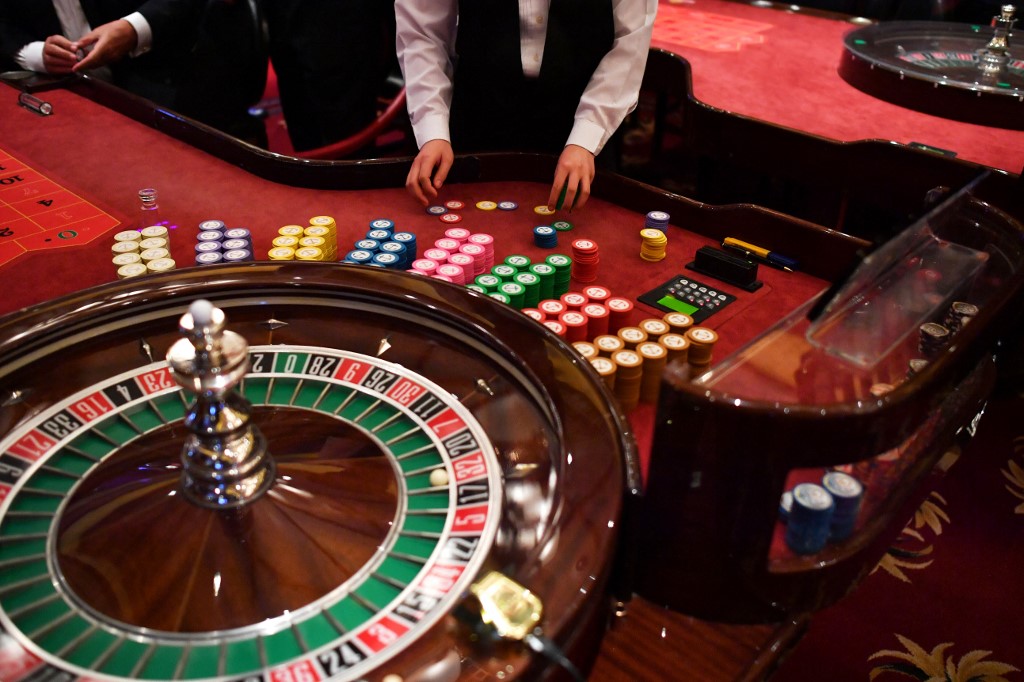 People play roulette at a casino.