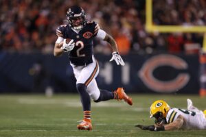 The cover for this NFL odds week 17 article shows DJ Moore #2 of the Chicago Bears carrying the ball after his reception against the Green Bay Packers.
