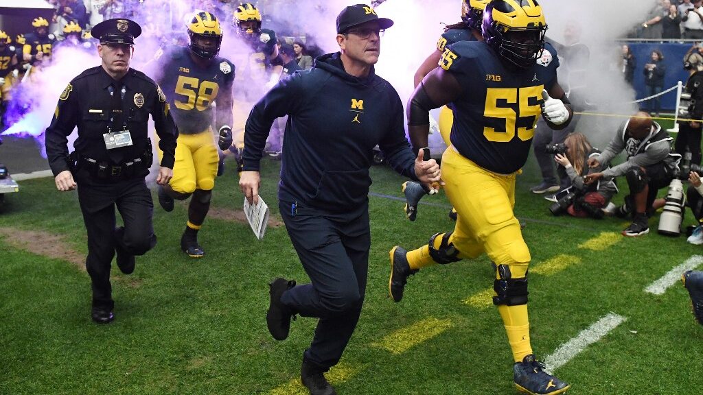 Head-coach-Jim-Harbaugh-of-the-Michigan-Wolverines-leads-his-team-on-the-field-aspect-ratio-16-9