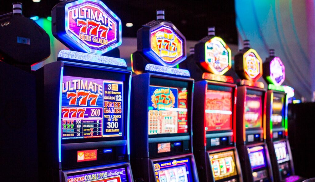 The picture shows rows of gaming machines at a casino.