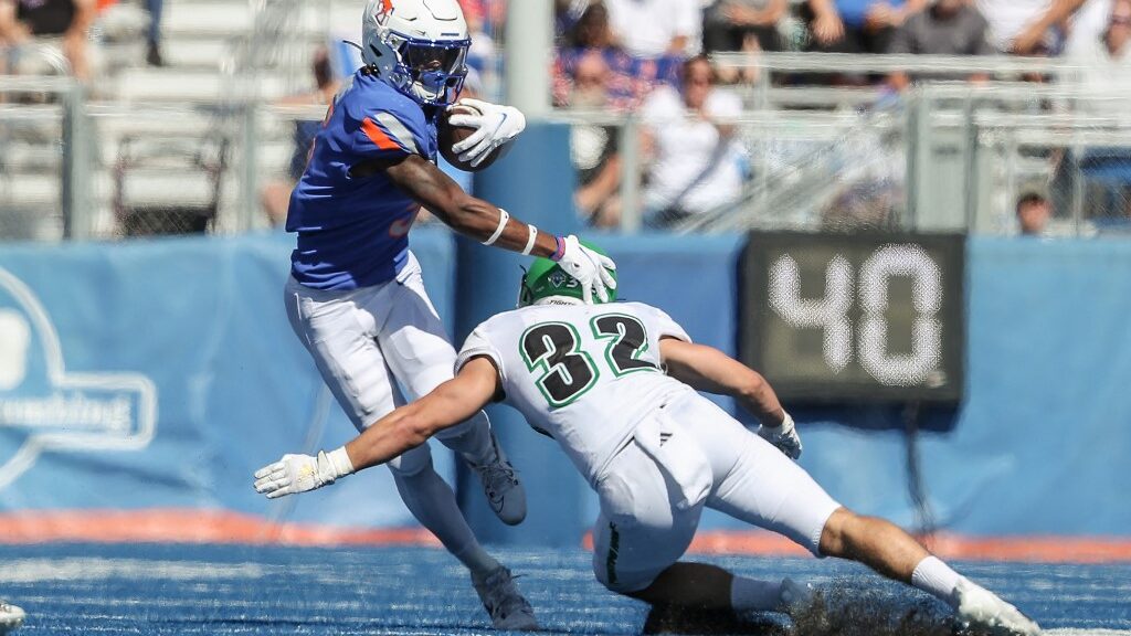 Wide-receiver-Stefan-Cobbs-5-of-the-Boise-State-Broncos-side-steps-the-tackle-attempt-of-linebacker-Dylan-Boecker-32-of-the-North-Dakota-Fighting-Hawks-aspect-ratio-16-9