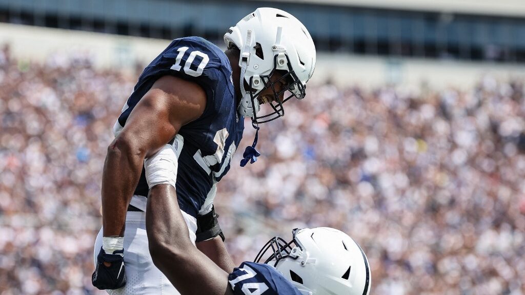 Nicholas-Singleton-10-of-the-Penn-State-Nittany-Lions-celebrates-with-Olumuyiwa-Fashanu-74-after-scoring-a-touchdown-against-the-Delaware-Fightin-Blue-Hens-aspect-ratio-16-9