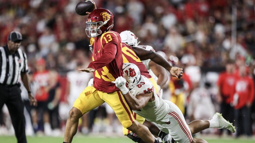 Caleb-Williams-13-of-the-USC-Trojans-looks-to-throw-a-pass-defended-by-Jonah-Elliss-83-of-the-Utah-Utes-aspect-ratio-16-9