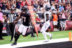 Woody Marks #27 of the Houston Texans scores a touchdown against Roger McCreary #21 of the Tennessee Titans
