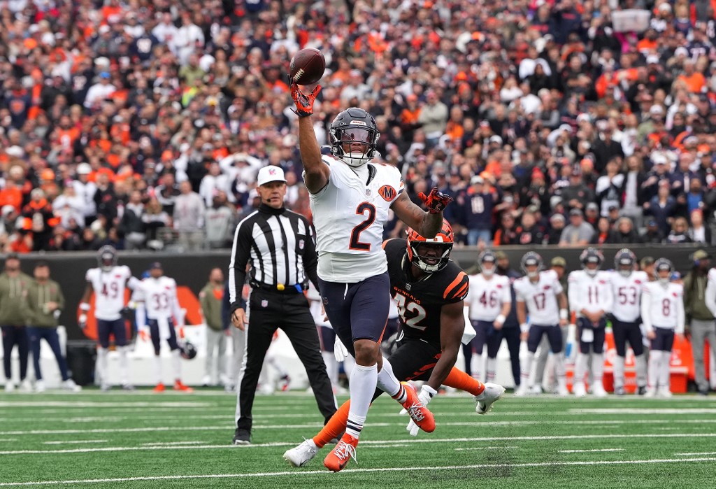The cover for this NFL odds week 10 article shows DJ Moore #2 of the Chicago Bears throwing a pass for a touchdown in the first quarter against the Cincinnati Bengals