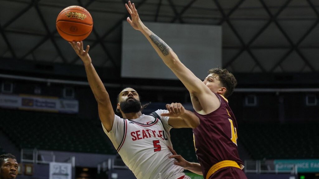 Cameron-Tyson-5-of-the-Seattle-Redhawks-extends-and-puts-up-a-shot-around-Quinn-Slazinski-11-of-the-Iona-Gaels-aspect-ratio-16-9