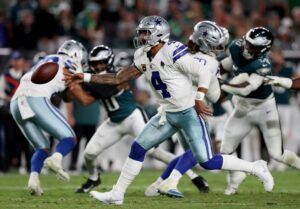 Dak Prescott #4 of the Dallas Cowboys flicks the ball against the Philadelphia Eagles. These two teams meet again this week for our NFL picks week 12.