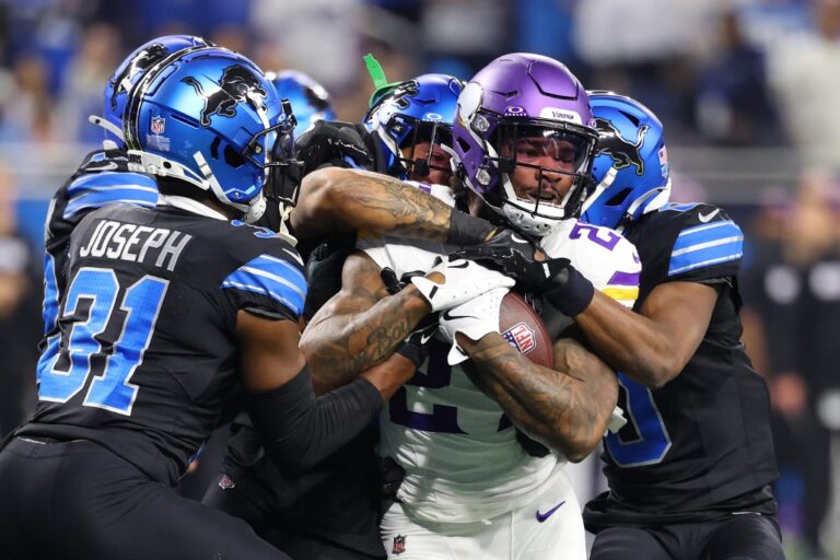 Cam Akers #27 of the Minnesota Vikings runs the ball against the Detroit Lions.