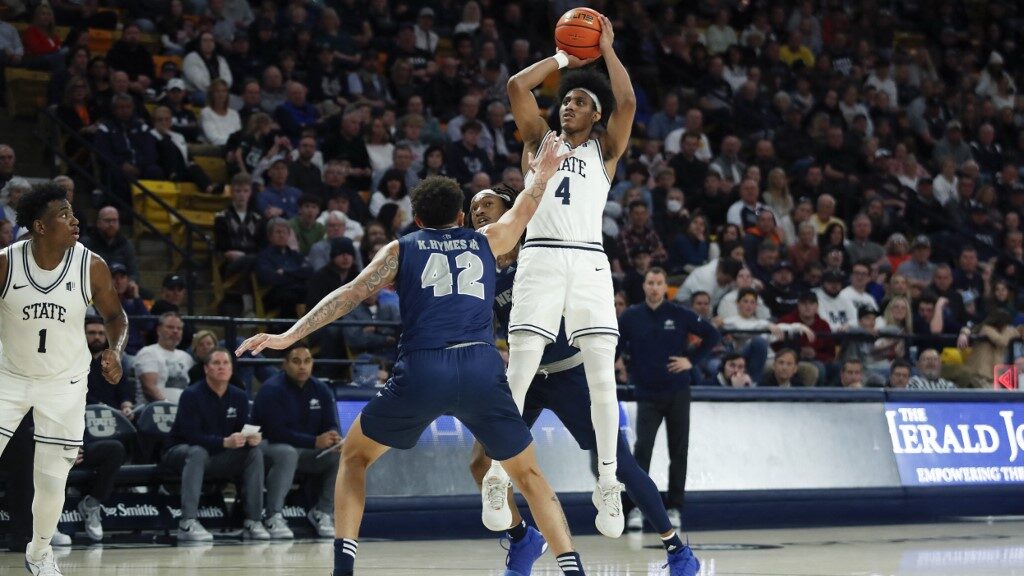 Ian-Martinez-4-of-the-Utah-State-Aggies-shoots-the-ball-against-K.J.-Hymes-42-of-the-Nevada-Wolf-Pack-during-the-second-half-aspect-ratio-16-9