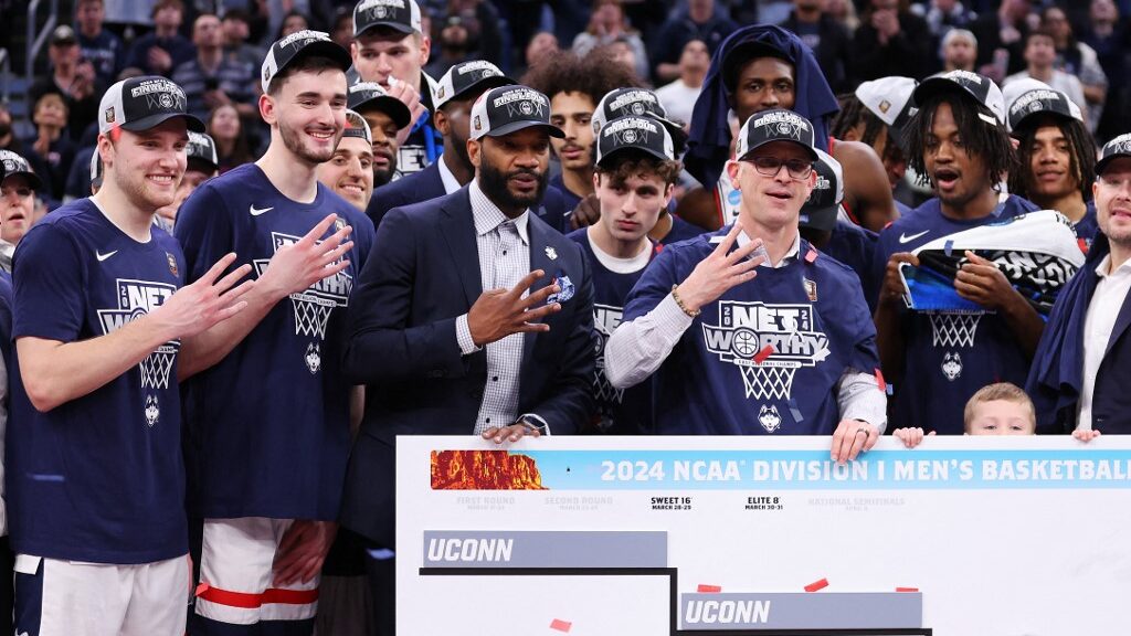 The-Connecticut-Huskies-celebrate-after-defeating-the-Illinois-Fighting-Illini-in-the-Elite-8-round-of-the-NCAA-Mens-Basketball-Tournament-at-TD-Garden-on-March-30-2024-aspect-ratio-16-9