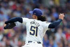 Freddy Peralta #51 of the Milwaukee Brewers throws a pitch against the St. Louis Cardinals.