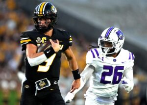 Quarterback Beau Pribula #9 of the Missouri Tigers runs for a touchdown against defensive back Sean Smith #26 of the Central Arkansas Bears
