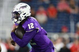 JC Evans #12 of the James Madison Dukes rushes against the Western Kentucky Hilltoppers.