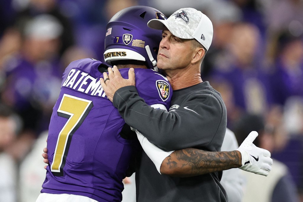 Head coach John Harbaugh and Rashod Bateman #7 of the Baltimore Ravens embrace before the game against the Cincinnati Bengals.