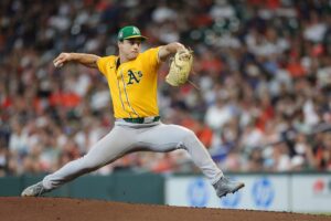 J.T. Ginn #70 of the Athletics pitches against the Houston Astros.