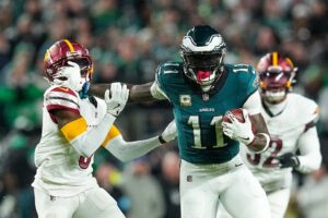 Mike Sainristil #0 of the Washington Commanders defends A.J. Brown #11 of the Philadelphia Eagles after a reception
