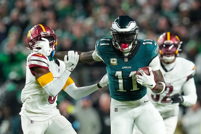 Mike Sainristil #0 of the Washington Commanders defends A.J. Brown #11 of the Philadelphia Eagles after a reception