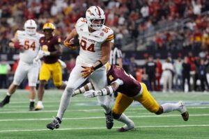 Gabe Burkle #84 of the Iowa State Cyclones carries the ball after his reception against Xavion Alford #2 of the Arizona State Sun Devils