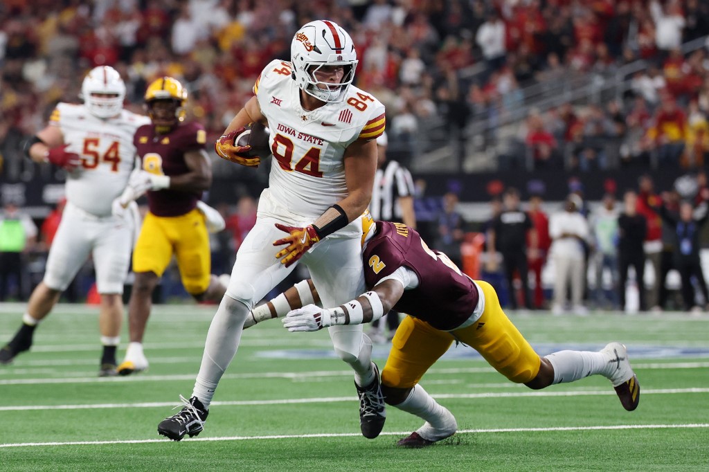 Gabe Burkle #84 of the Iowa State Cyclones carries the ball after his reception against Xavion Alford #2 of the Arizona State Sun Devils