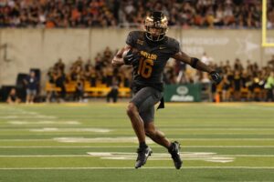 Kobe Prentice #16 of the Baylor Bears runs for yards during a game against the Auburn Tigers.