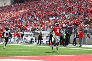 Jeremiah Smith #4 of the Ohio State Buckeyes runs for a touchdown in the first quarter of a game against the Grambling State Tigers