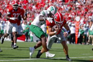 Gunner Stockton #14 of the Georgia Bulldogs rushes in to score against Marvae Myers #3 of the Marshall Thundering Herd
