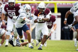 Jamarion Morrow #23 of the Texas A&M Aggies carries the ball in the second half of a game against the Utah State Aggies