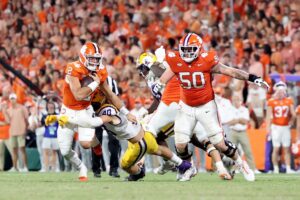 Quarterback Cade Klubnik #2 of the Clemson Tigers takes control of ball as linebacker Whit Weeks #40 of the LSU Tigers defends