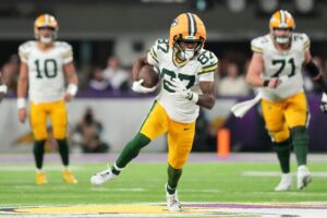 Romeo Doubs #87 of the Green Bay Packers runs with the ball against the Minnesota Vikings.