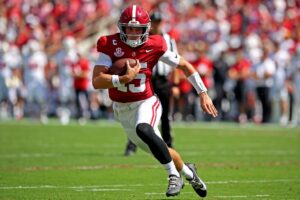 Ty Simpson #15 of the Alabama Crimson Tide rushes for a first down against the Wisconsin Badgers