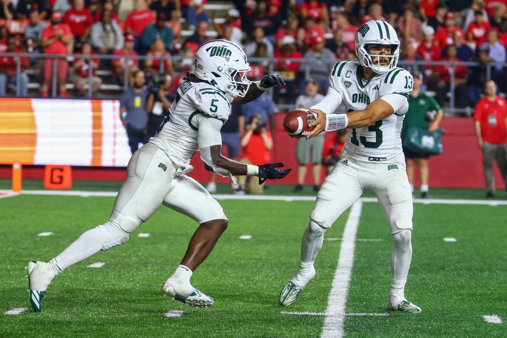 Parker Navarro #13 of the Ohio Bobcats hands to Sieh Bangura #5 of the Ohio Bobcats during the second half against the Rutgers Scarlet Knights
