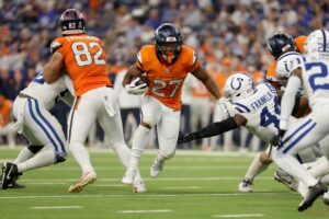 J.K. Dobbins #27 of the Denver Broncos runs with the ball during the second half against the Indianapolis Colts