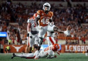 Smith Orogbo #46 of the Texas Longhorns celebrates after sacking Hunter Watson #10 of the Sam Houston State Bearkats