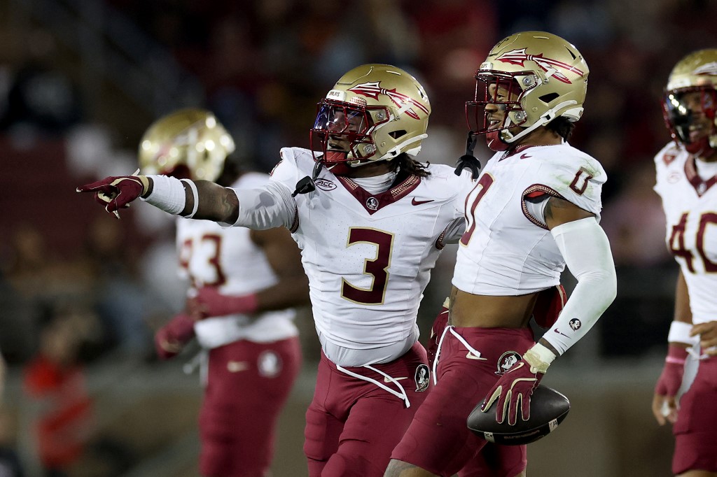 Edwin Joseph and Earl Little Jr. of the Florida State Seminoles celebrate an intercepted pass against the Stanford Cardinal.