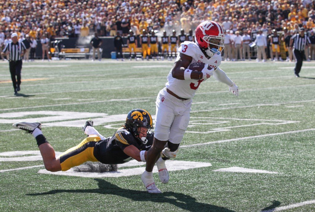 Wide receiver Omar Cooper Jr. #3 of the Indiana Hoosiers is tackled in the first half by defensive back Koen Entringer #4 of the Iowa Hawkeyes