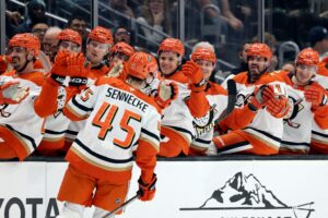 Beckett Sennecke #45 of the Anaheim Ducks celebrates with teammates after scoring his first career NHL goal against the Seattle Kraken.
