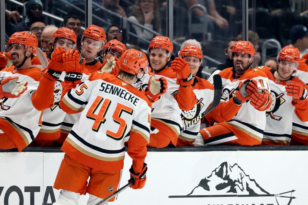 Beckett Sennecke #45 of the Anaheim Ducks celebrates with teammates after scoring his first career NHL goal against the Seattle Kraken.