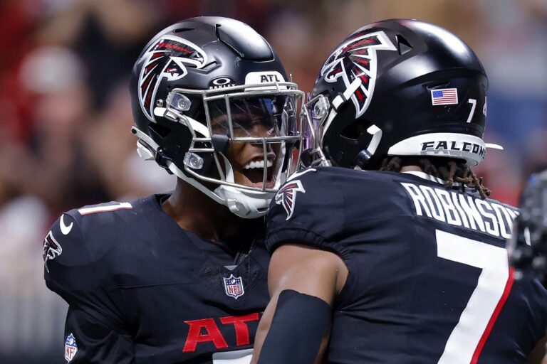 Bijan Robinson #7 and James Pearce Jr. #27 of the Atlanta Falcons celebrate a touchdown against the Washington Commanders.