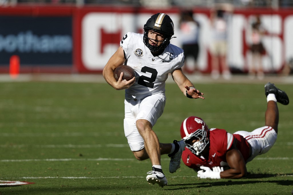 Diego Pavia #2 of the Vanderbilt Commodores gets around Nikhai Hill-Green #41 of the Alabama Crimson Tide as he carries the ball