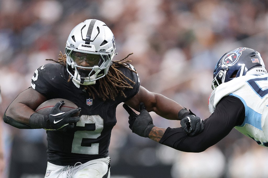 Ashton Jeanty #2 of the Las Vegas Raiders caries the ball against the Tennessee Titans.