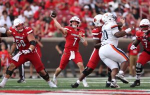 Miller Moss #7 of the Louisville Cardinals throws the ball against the Virginia Cavaliers