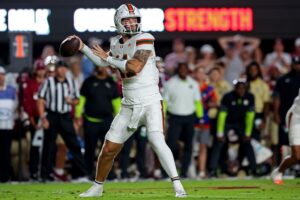 Carson Beck #11 of the Miami Hurricanes prepares to throw a pass in the first half of the game against the Florida State Seminoles